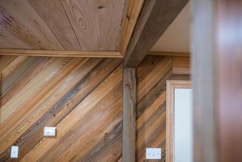 Sinker Cypress, KD, horizontal pattern on wall, natural finish;  pecky on ceiling with winter white stain; sinker 4 x 4 posts natural color; trim around ceiling and casing around door frame are cypress mouldings,  clear finish. </br></br>